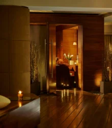 Cosy couple enjoys a warm, inviting spa at a luxury hotel with soft lighting and elegant decor.