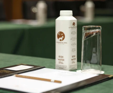 O'Donoghue Ring branded water and glass on a conference table.