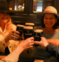 A cheerful group enjoying Guinness pints in a cosy pub setting.