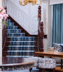 Elegant hotel lobby with comfortable seating and stylish staircase.