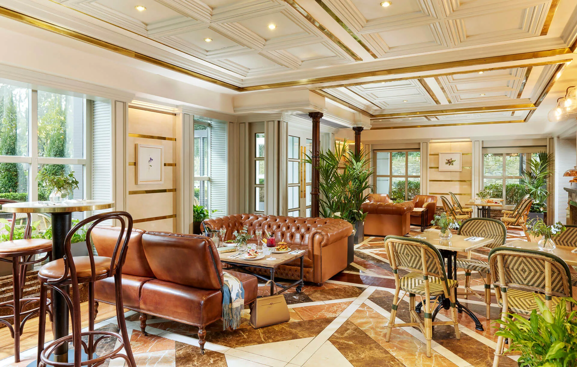 Warm hotel lounge with cosy seating and natural light, perfect for relaxation.