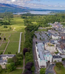 Aerial view of a picturesque town with lush green parks and scenic landscapes.