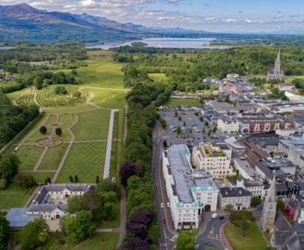 Aerial view of a picturesque town with lush green parks and scenic landscapes.