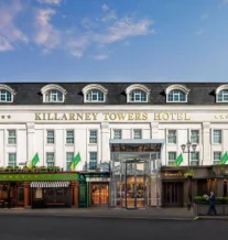 Elegant exterior of Killarney Towers Hotel under a blue sky.