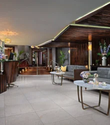 Elegant hotel lobby with inviting seating, fresh flowers, and a warm, welcoming atmosphere.