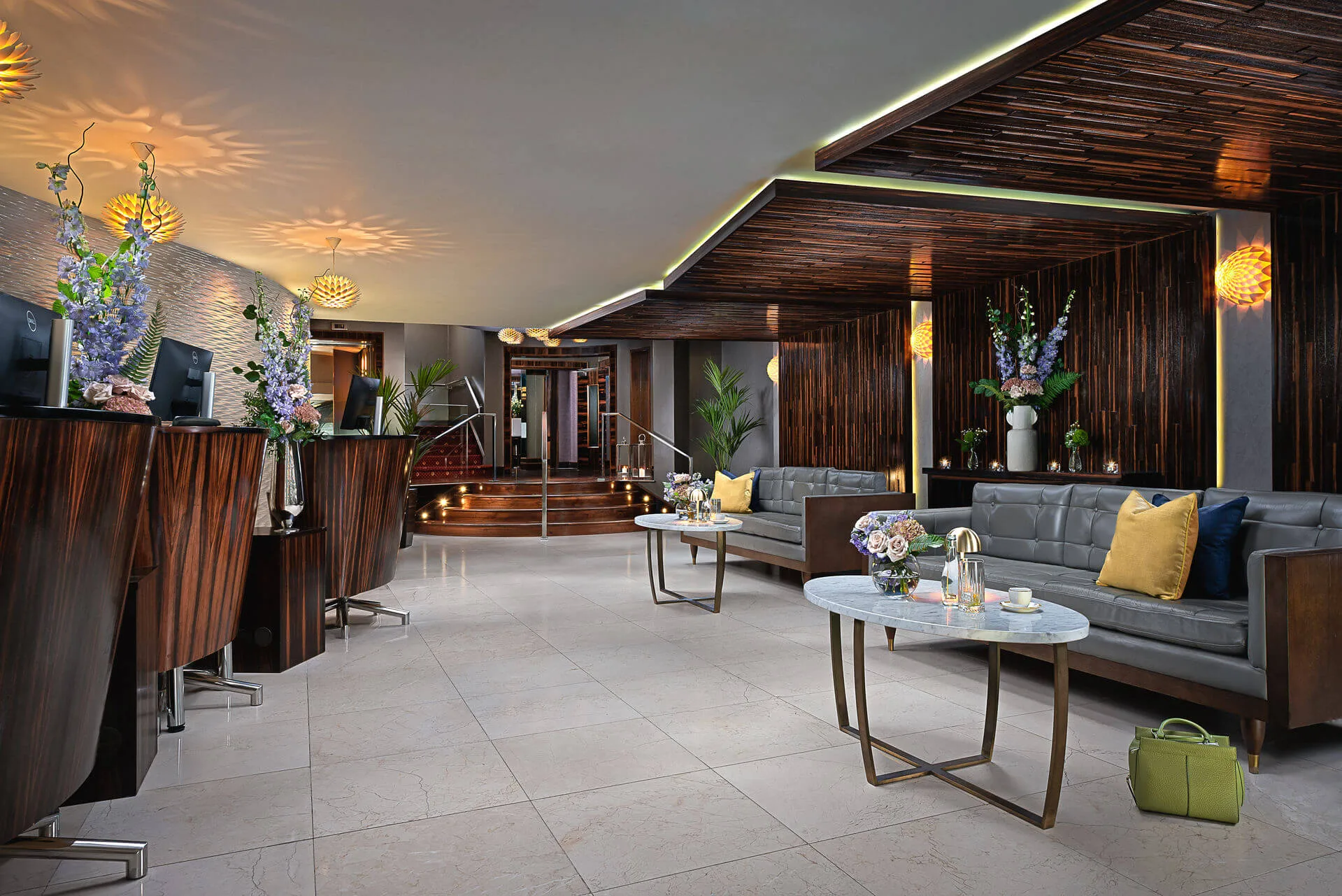 Elegant hotel lobby with inviting seating, fresh flowers, and a warm, welcoming atmosphere.