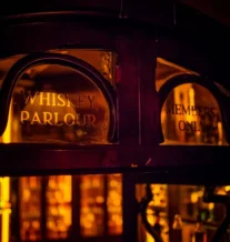 Cosy whiskey parlour with warm lighting for members