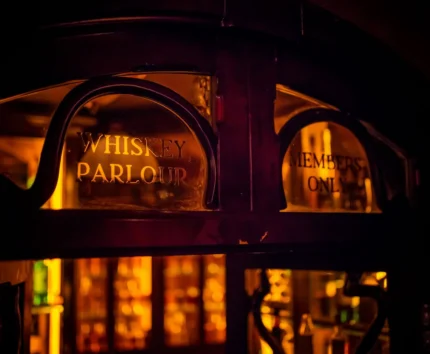 Cosy whiskey parlour with warm lighting for members