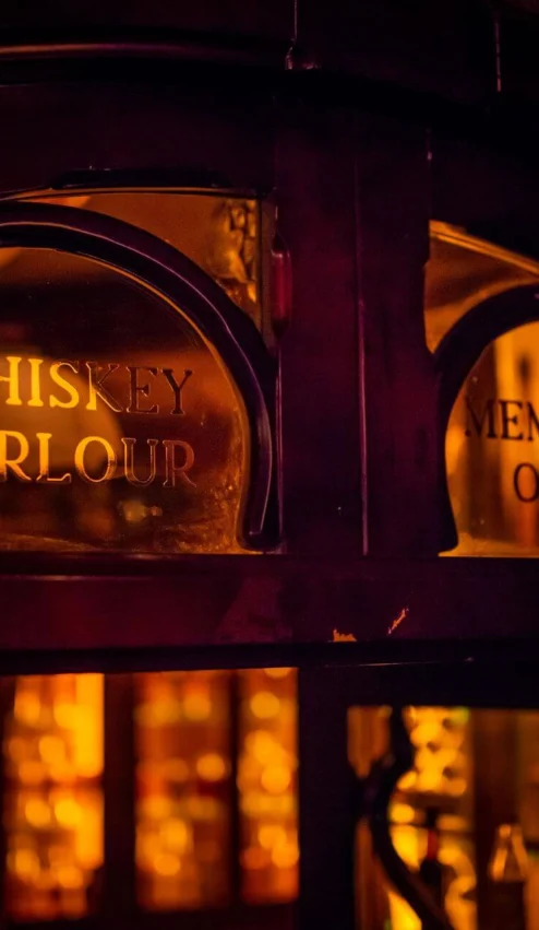 Cosy whiskey parlour with warm lighting for members