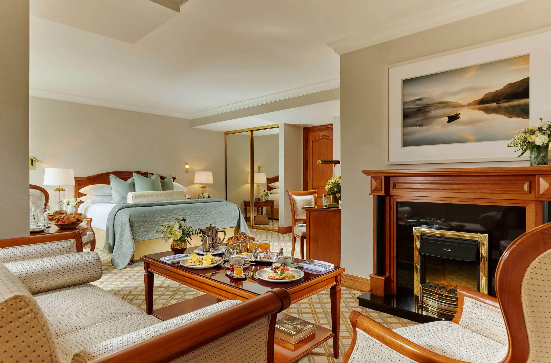 Cosy hotel room with breakfast served for a family on a wooden table.