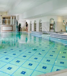 Family enjoying a luxurious indoor pool at Killarney Towers Hotel.