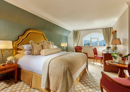 Cosy hotel room with plush bed, elegant decor, and mountain view.