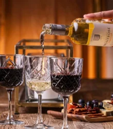 An inviting table setting with wine and appetisers, perfect for a cosy gathering.