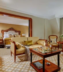 Luxurious hotel suite with a comfortable living area and scenic mountain view.