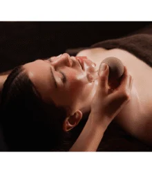 Relaxed couple enjoying a soothing facial cupping therapy in a warm spa treatment room, towel visible
