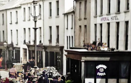 Historic street scene with families and shops, outside the Imperial Hotel.